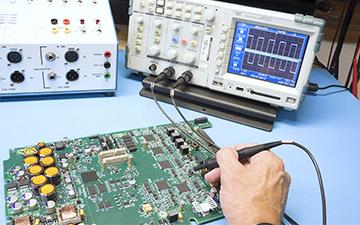 Close-up of a hand working on an application-specific integrated circuit (ASIC) for enhanced space technology